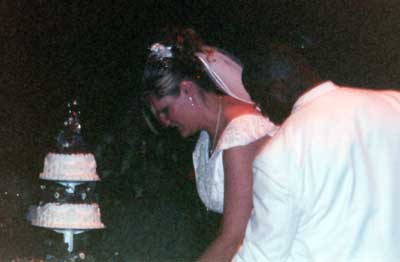 Summer and Anthony cut the wedding cake